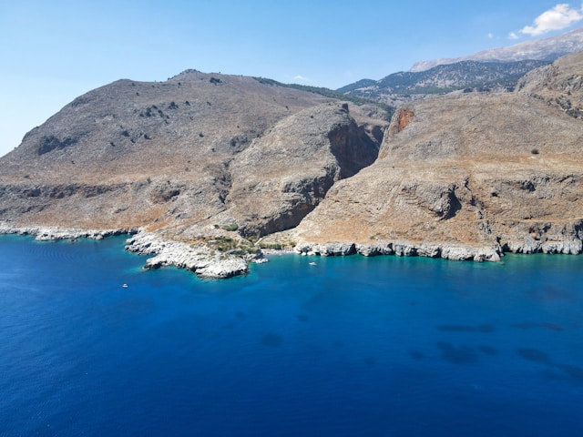 aegean-sea-land-sky A wide-angle view of the blue Aegean sea meeting the Cycladic islands and the clear sky from the deck of Calypso